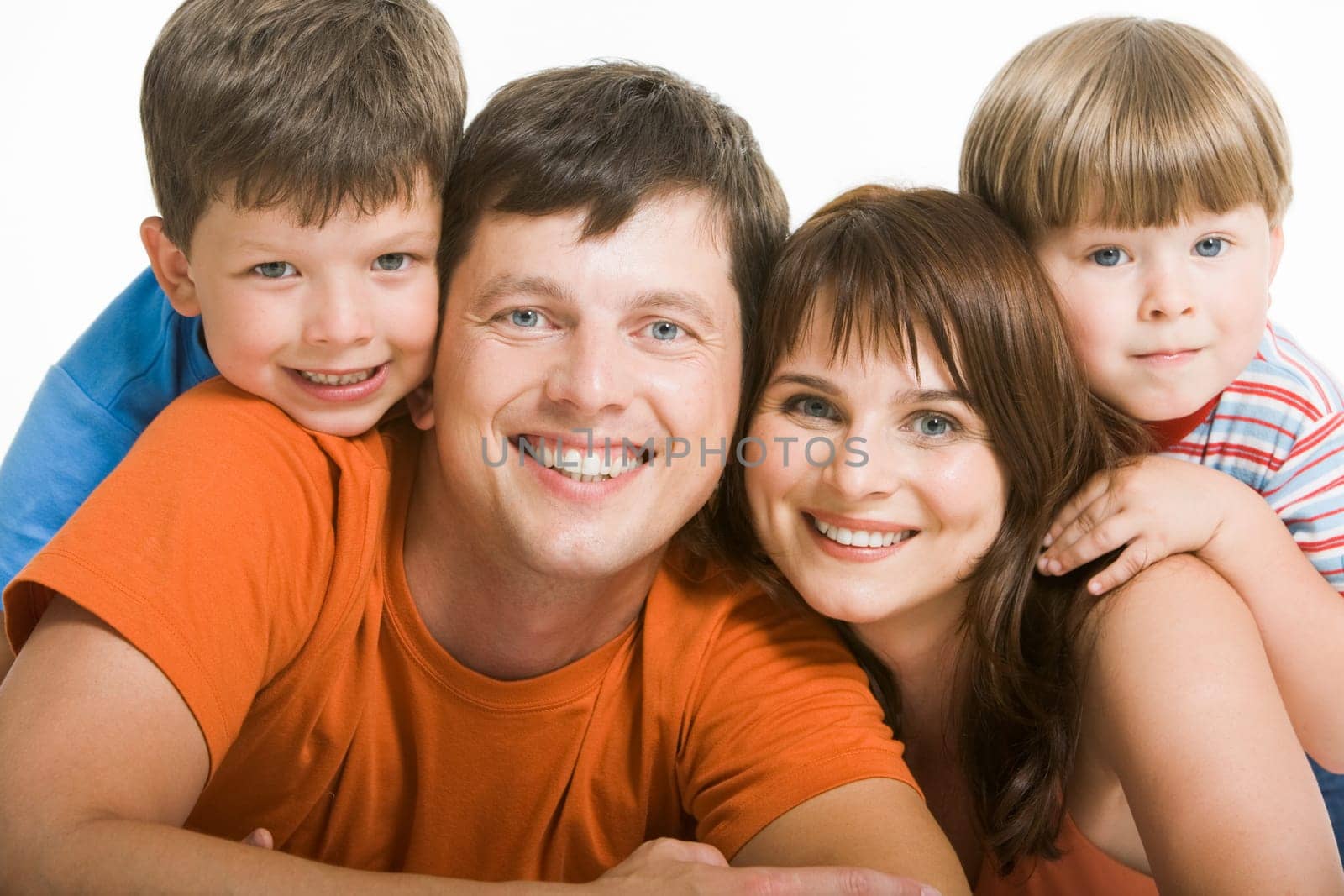 Portrait of joyful family laughing and looking at camera on white background