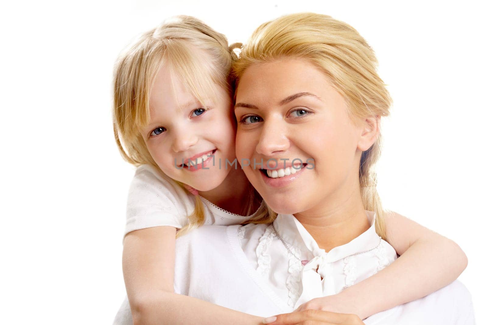 Portrait of little girl embracing woman wearing white clothes