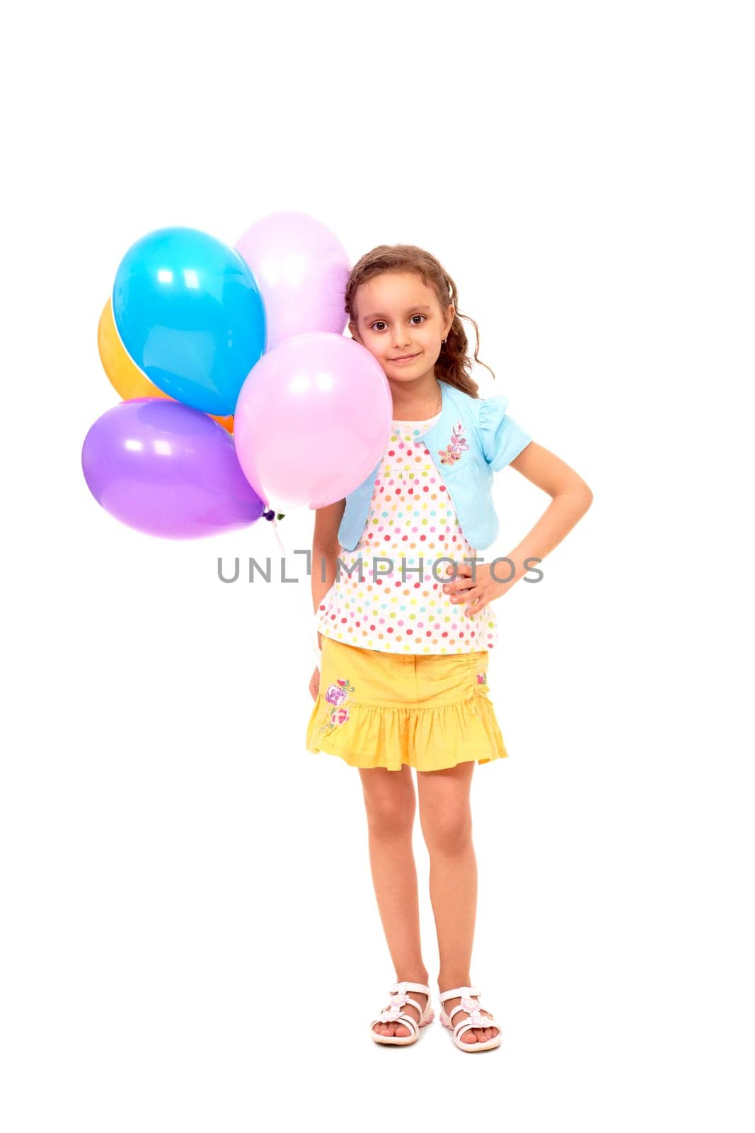 Portrait of happy girl with colorful balloons on white background