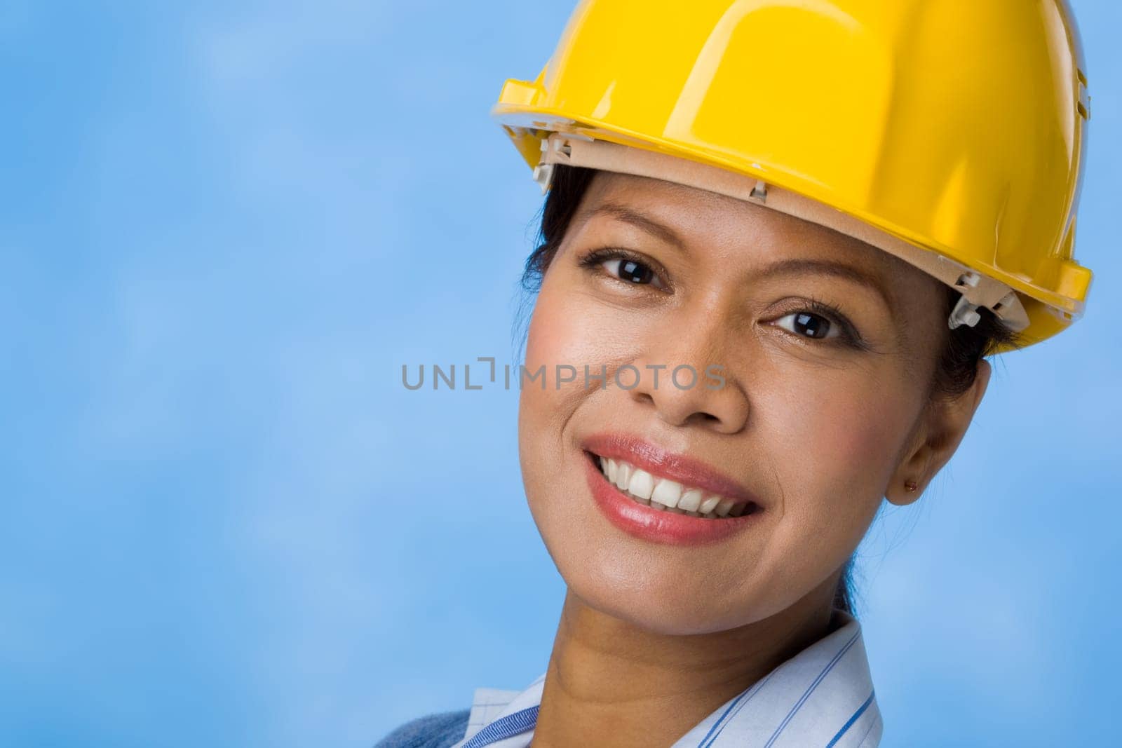 Portrait of pretty female with helmet on head looking at camera