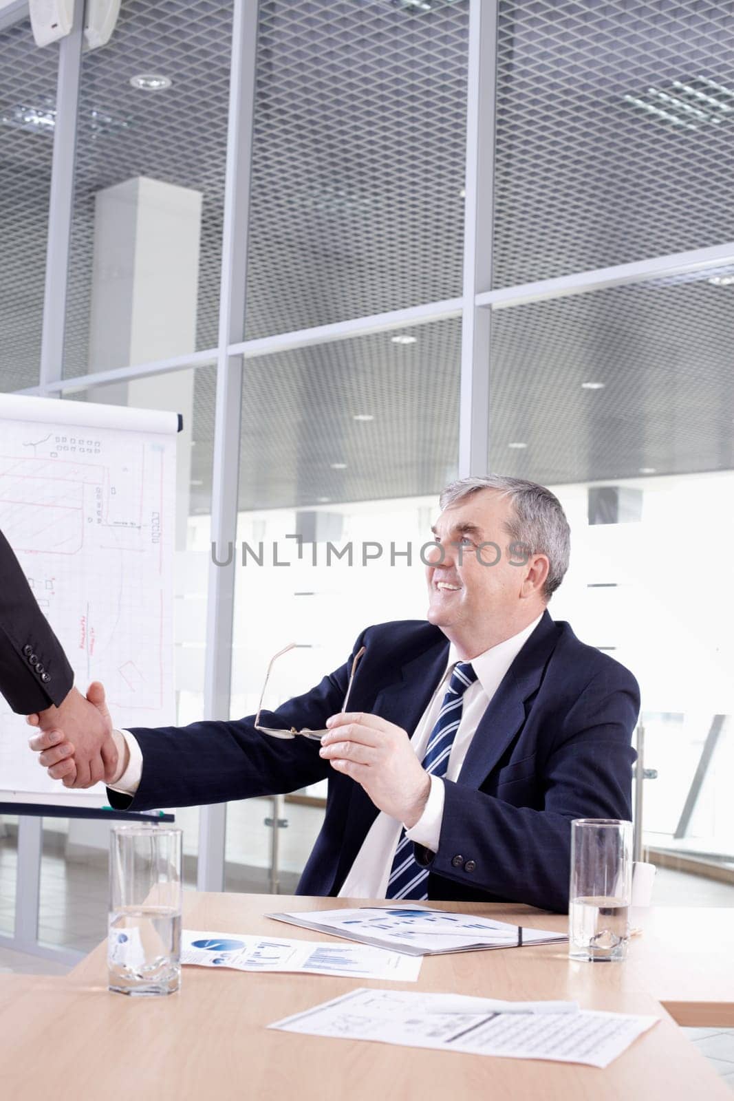Senior chief shaking hands with his partner