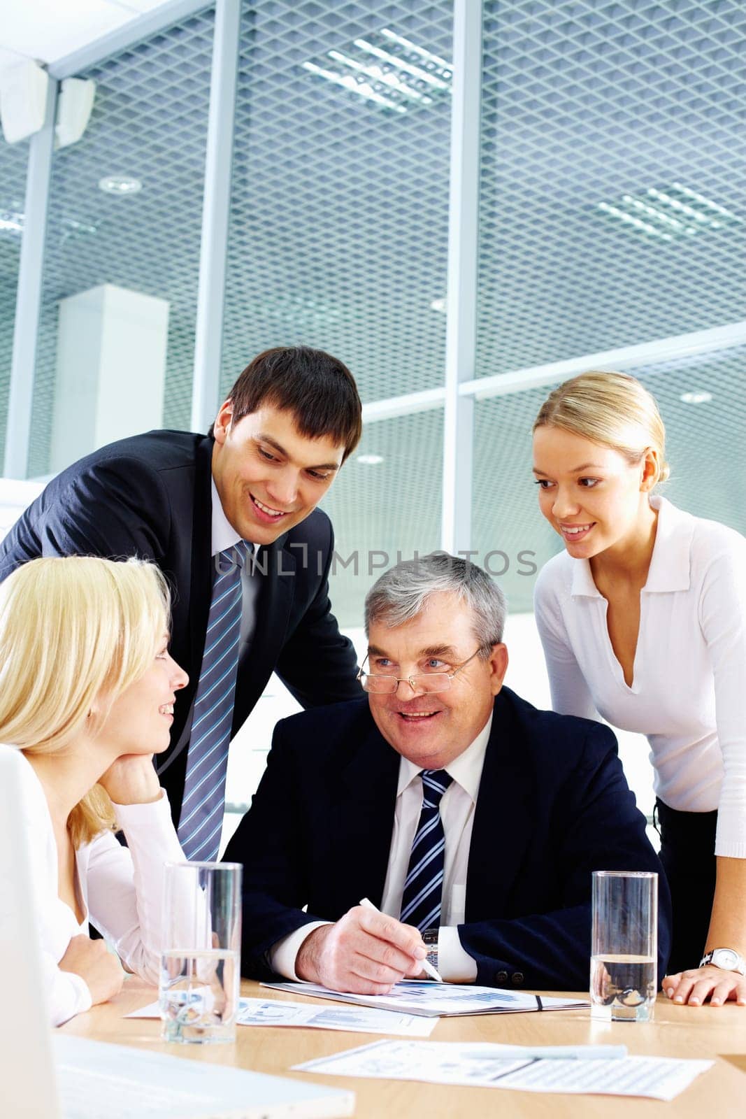 Business team of four people interacting in office at meeting