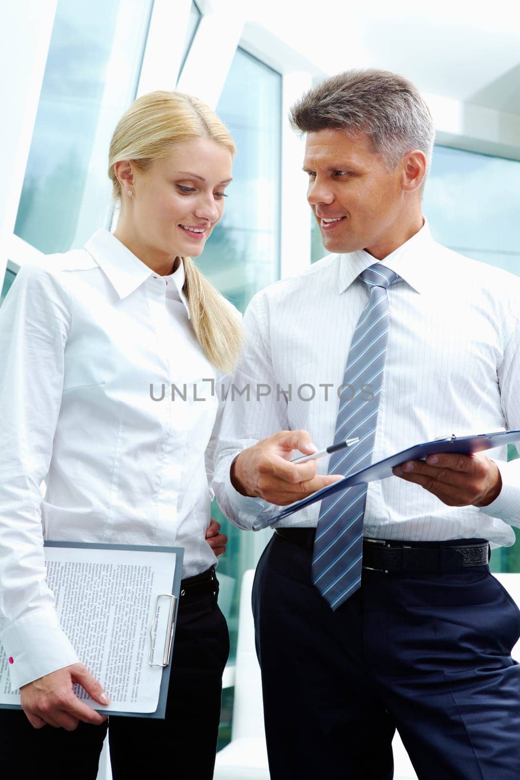 Two smart employees discussing new strategy at meeting