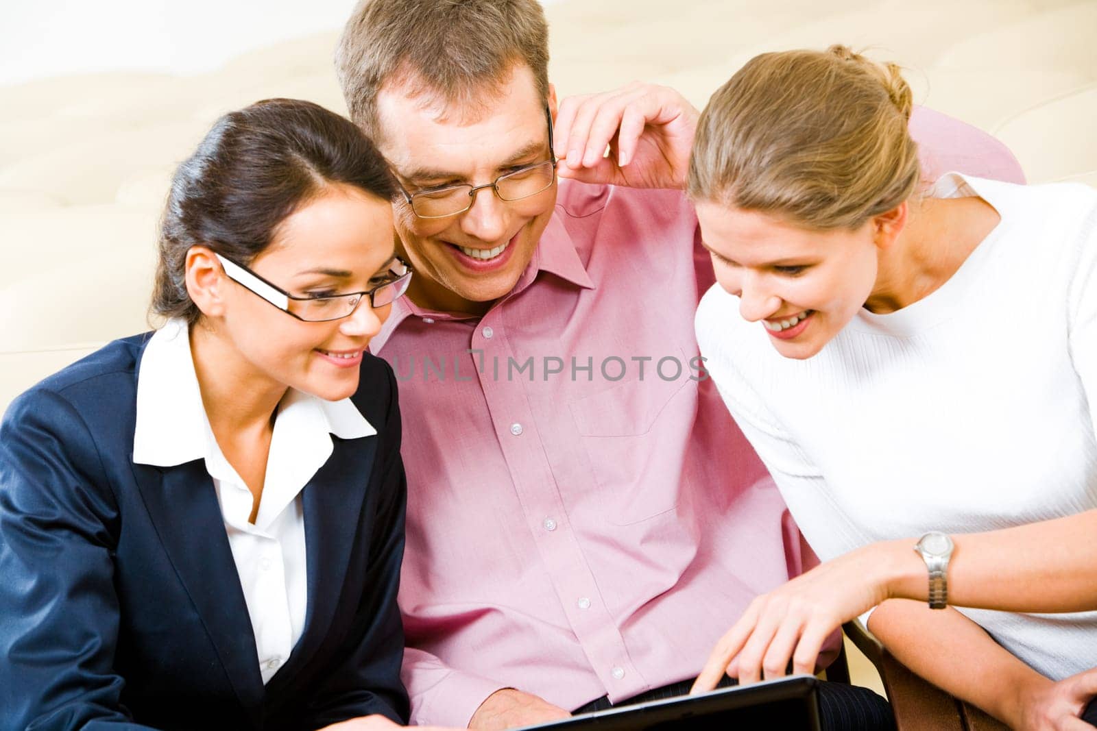 Team of three business people looking at monitor