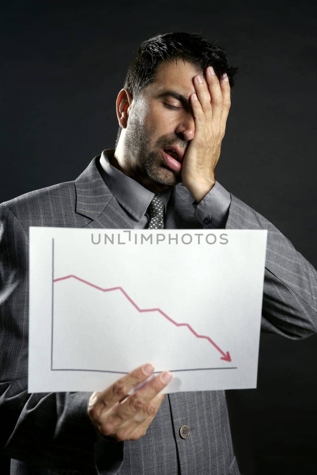 Businessman with bad sales reports chart. Crisis