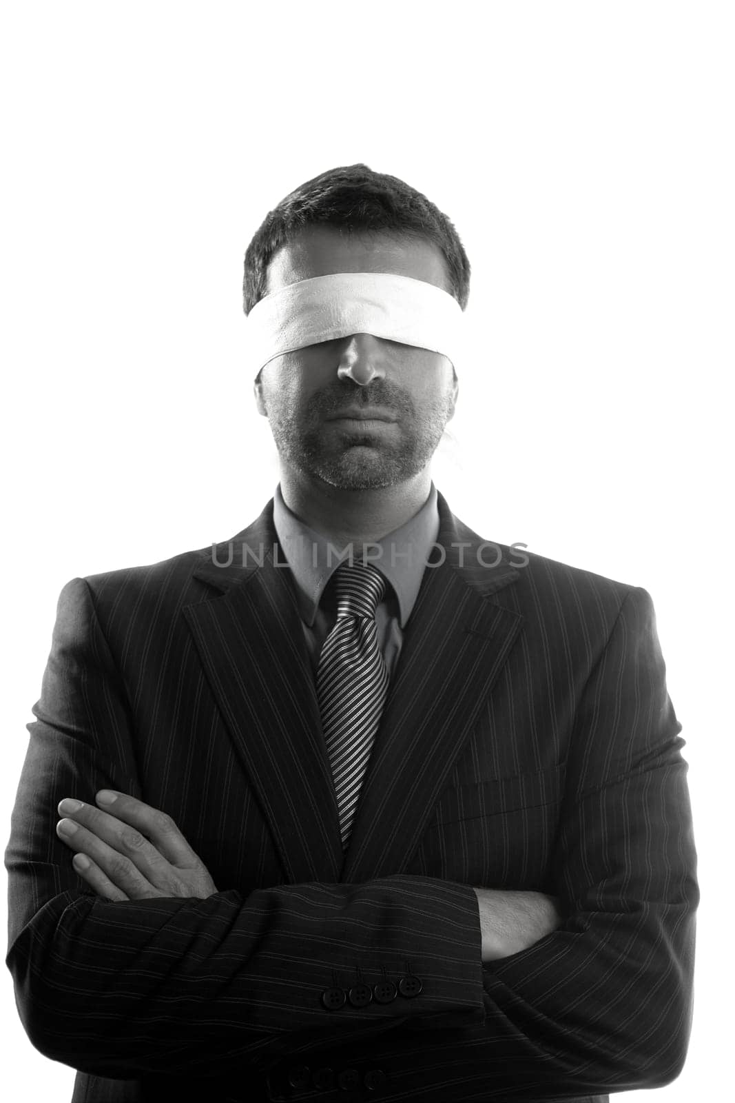 Blindfolded businessman over white background, conceptual image
