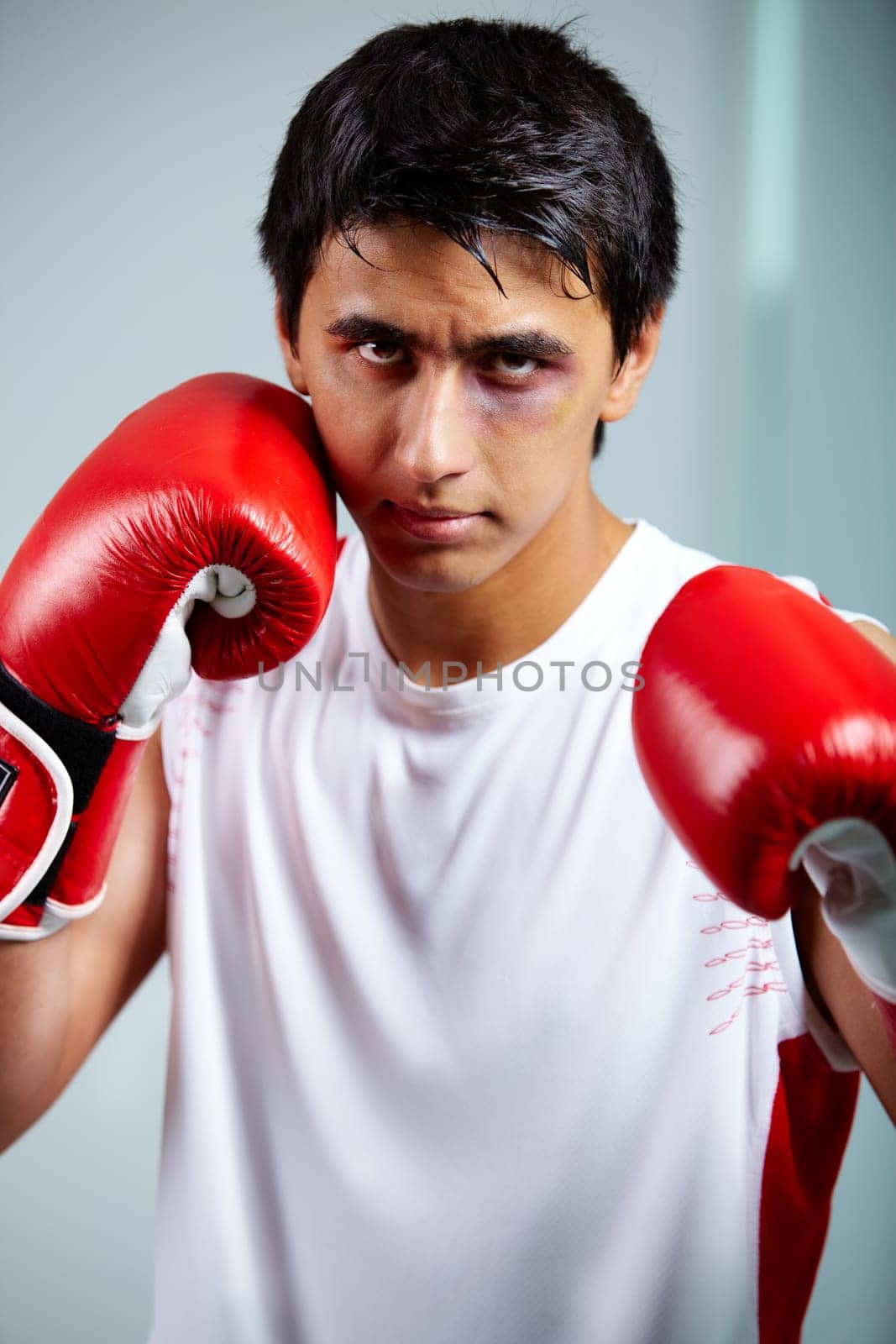 Image of a boxer in red gloves ready to attack his rival