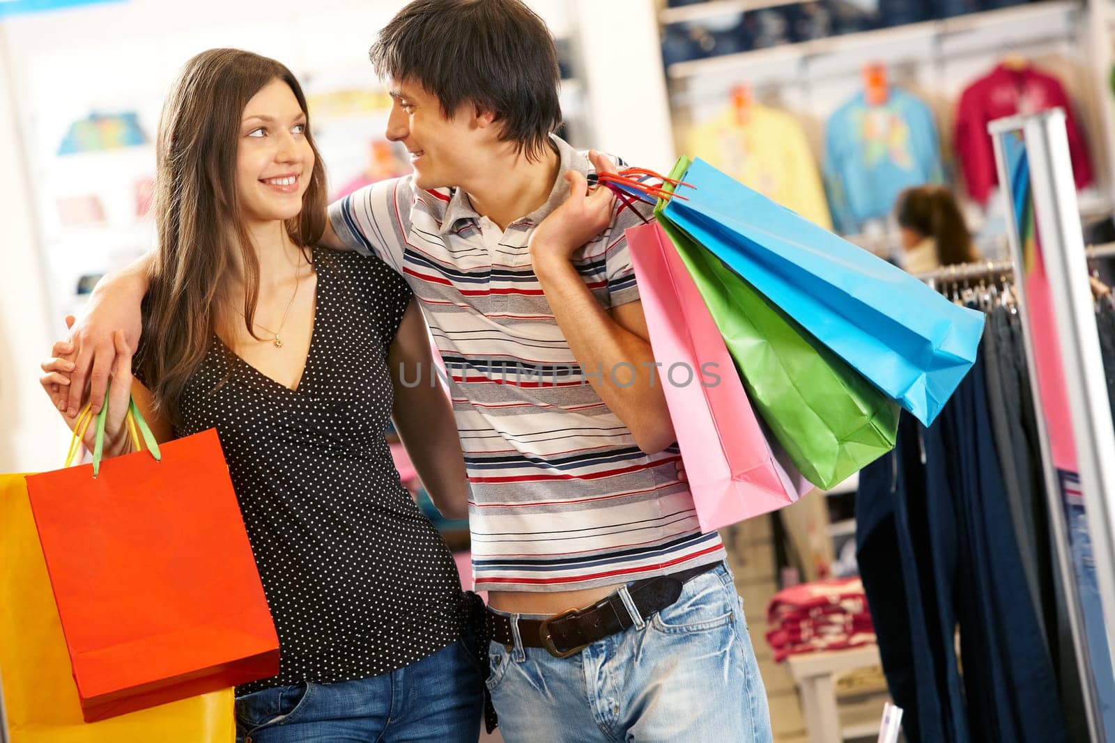 Portrait of smiling husband and wife looking at each other in the mall