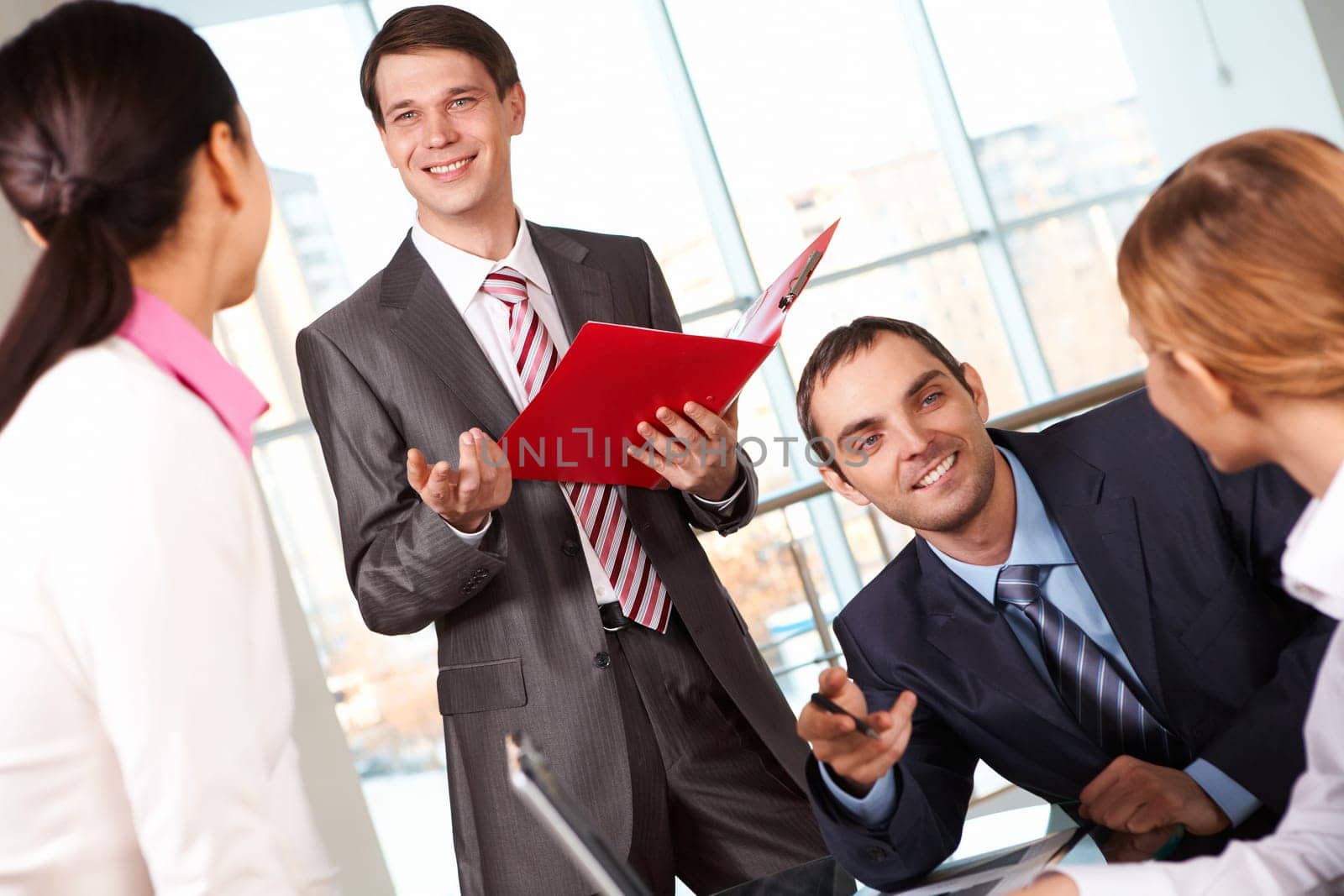 Image of businessmen answering questions of colleagues at meeting