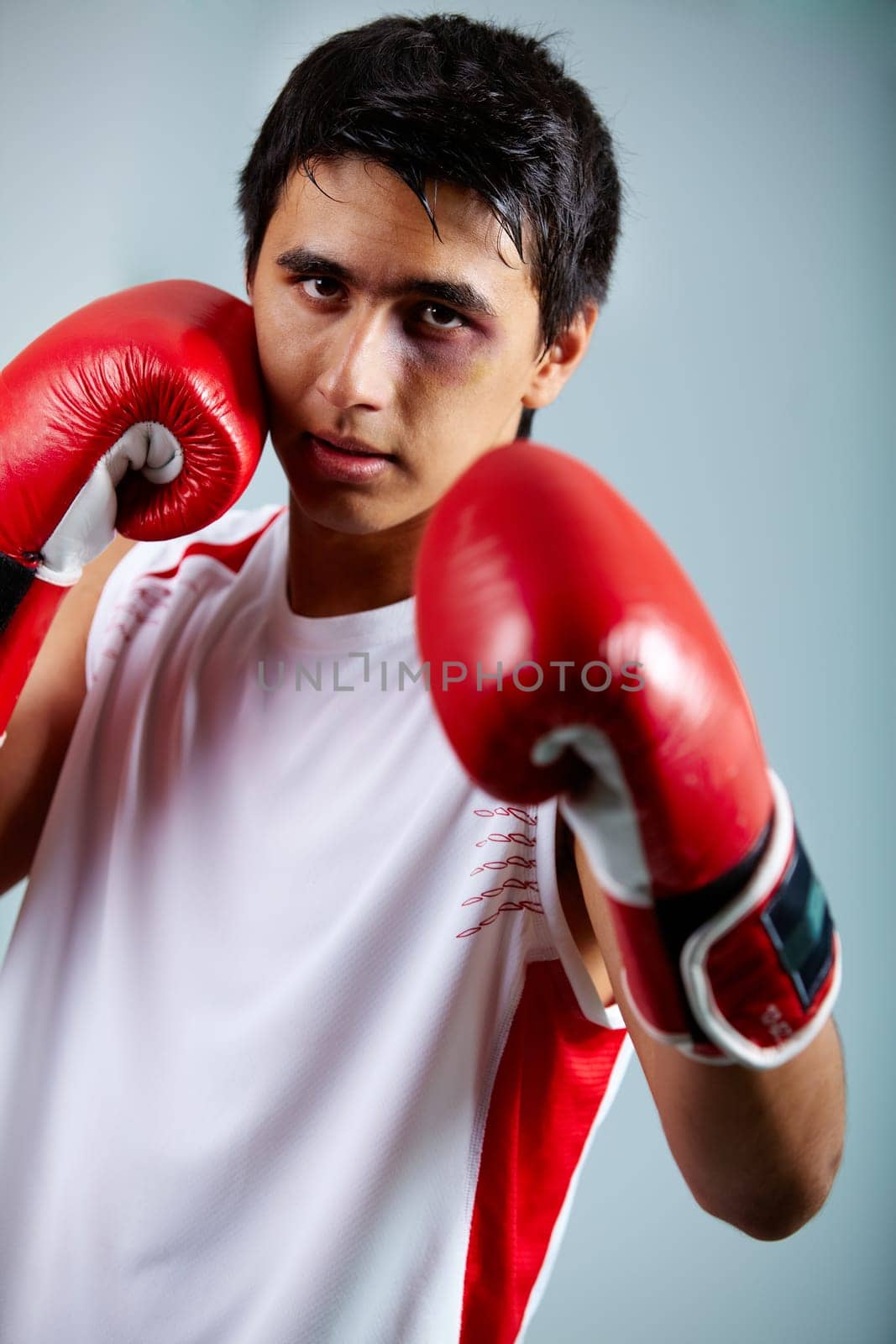 Image of a boxer in red gloves ready to attack his rival