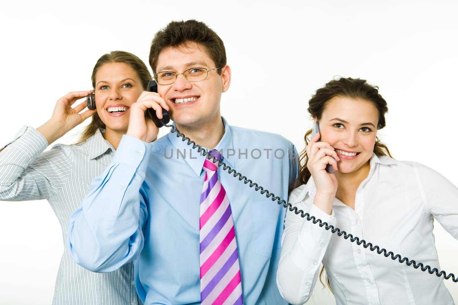 Group of smiling consultants speaking on their phones on white background with man between women