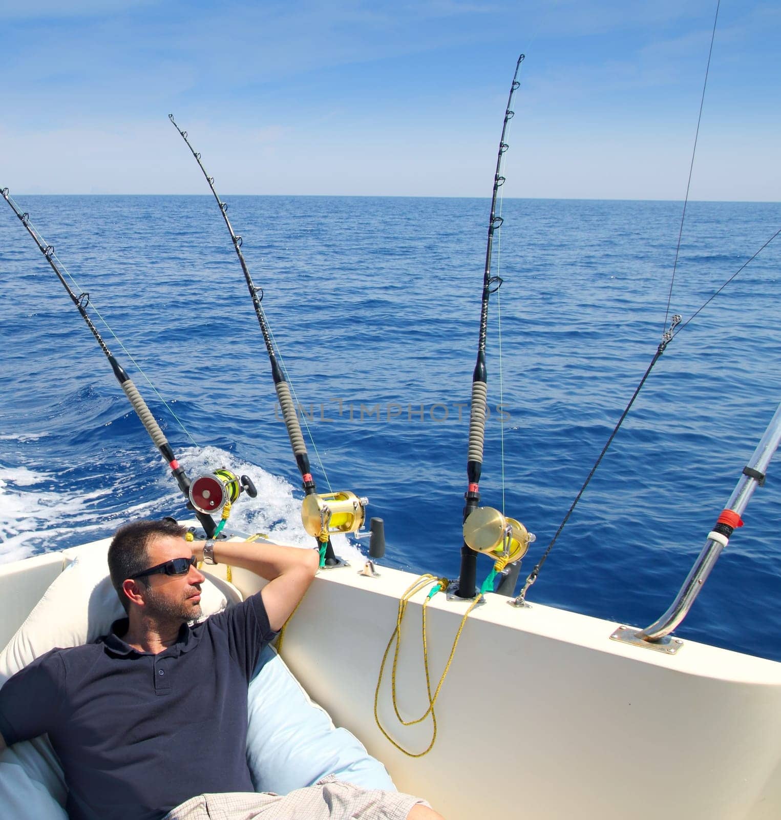 Sailor man fishing resting in boat summer vacation blue sea