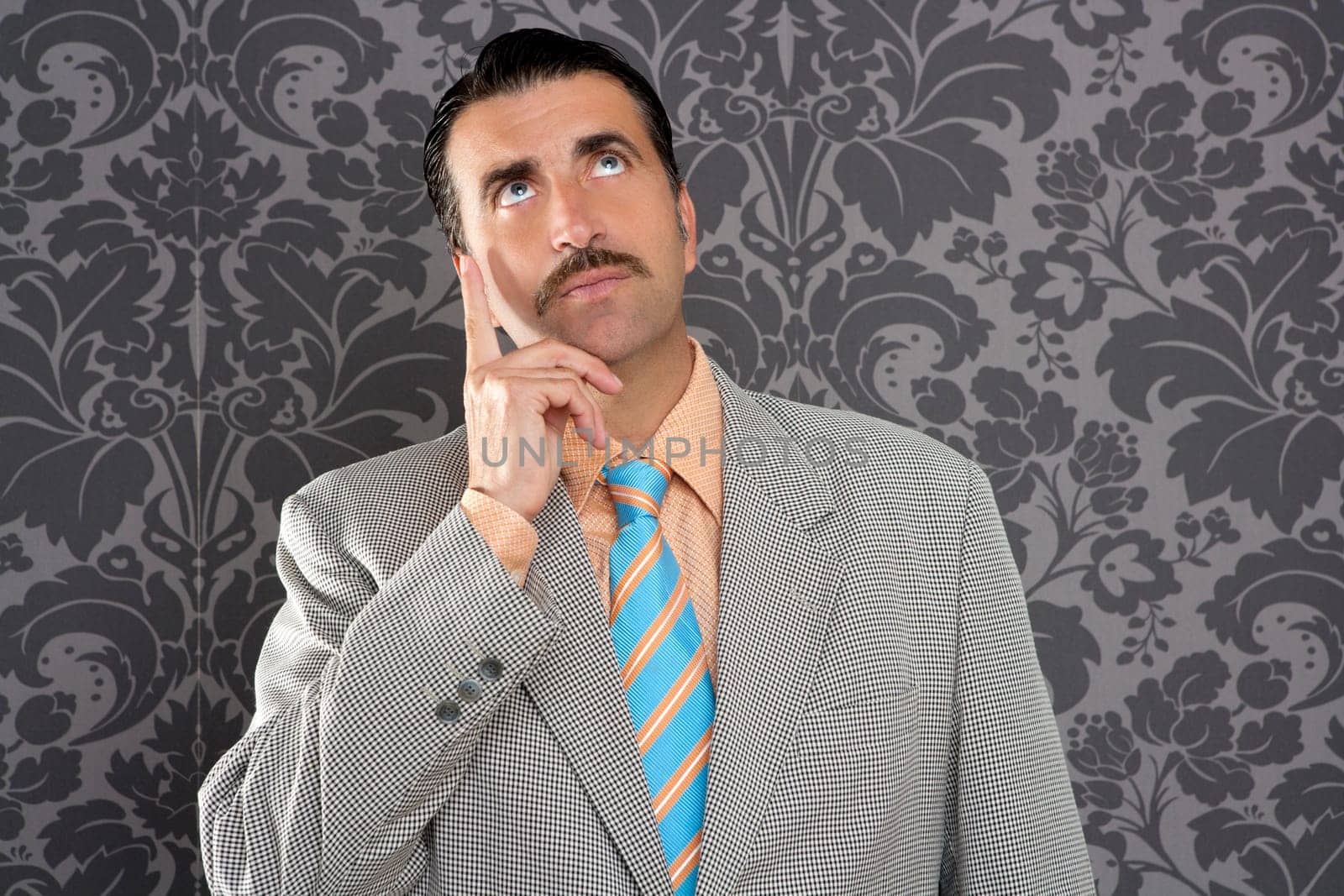 mustache retro salesman with vintage suit and pensive gesture in wallpaper