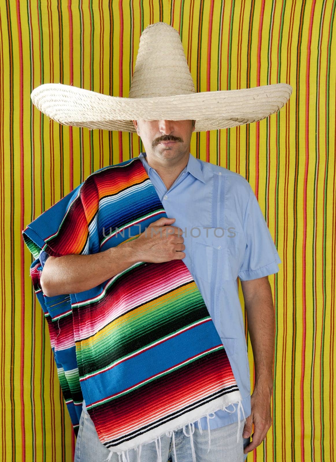 Mexican man serape poncho hat sombrero yellow stripes background