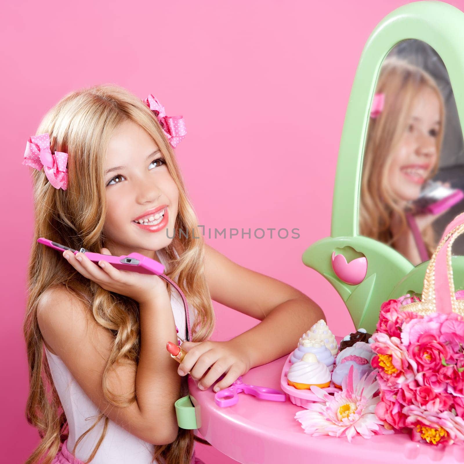 blond fashion doll girl talking with mobile phone in pink vanity