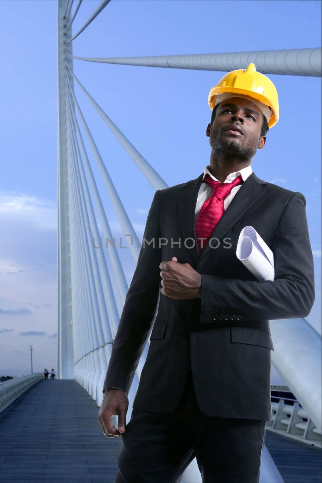 African american architect engineer with yellow hardhat and plans