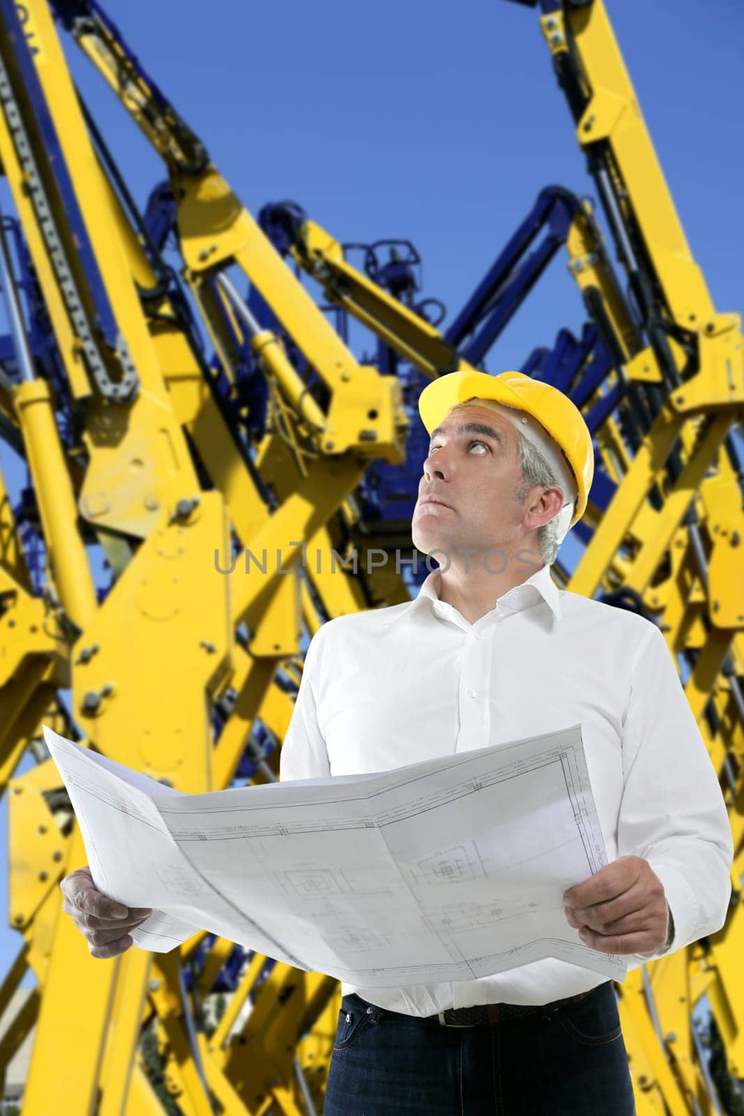 expertise architect senior engineer plan in hands yellow industrial cranes