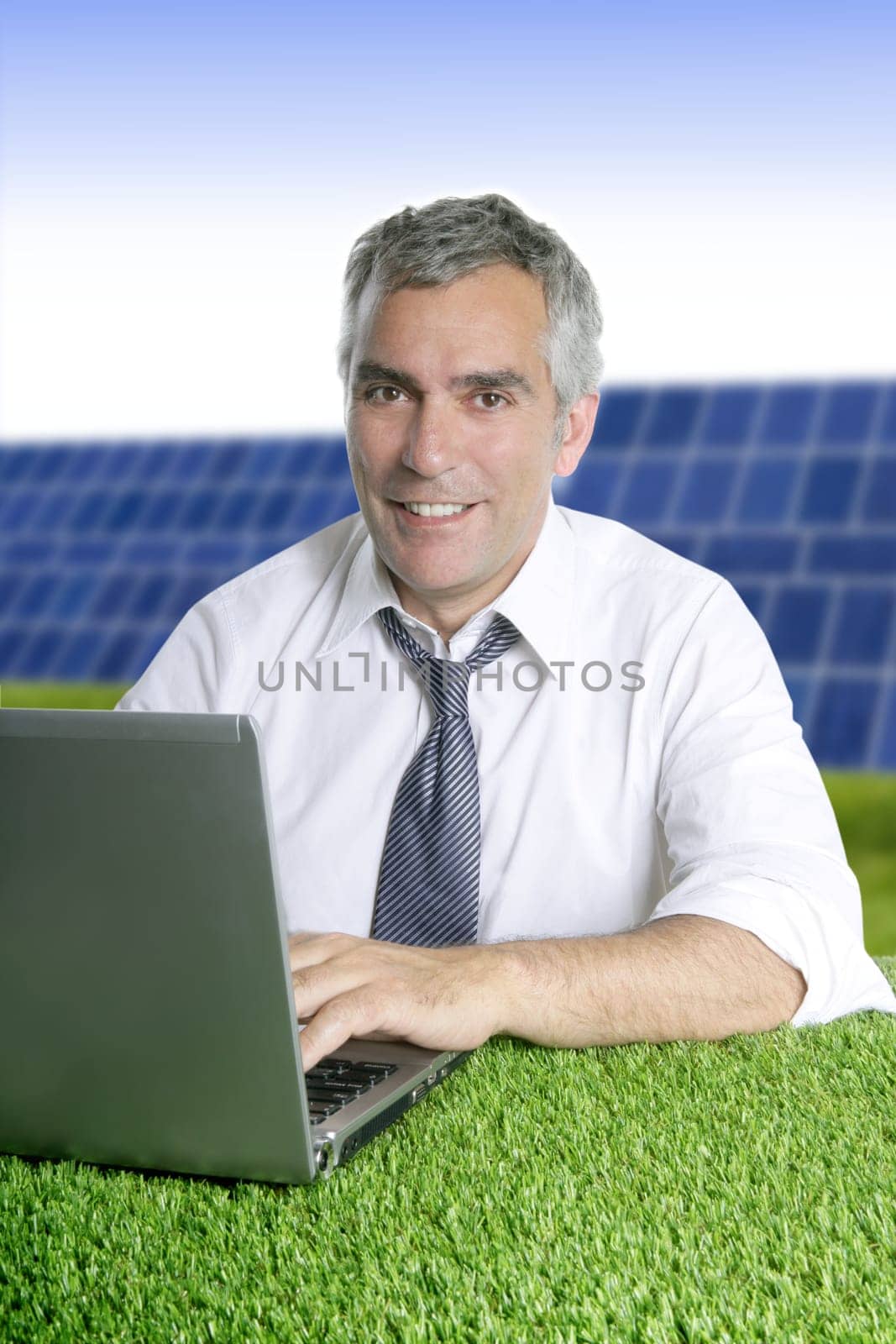senior businessman working green grass desk solar plates