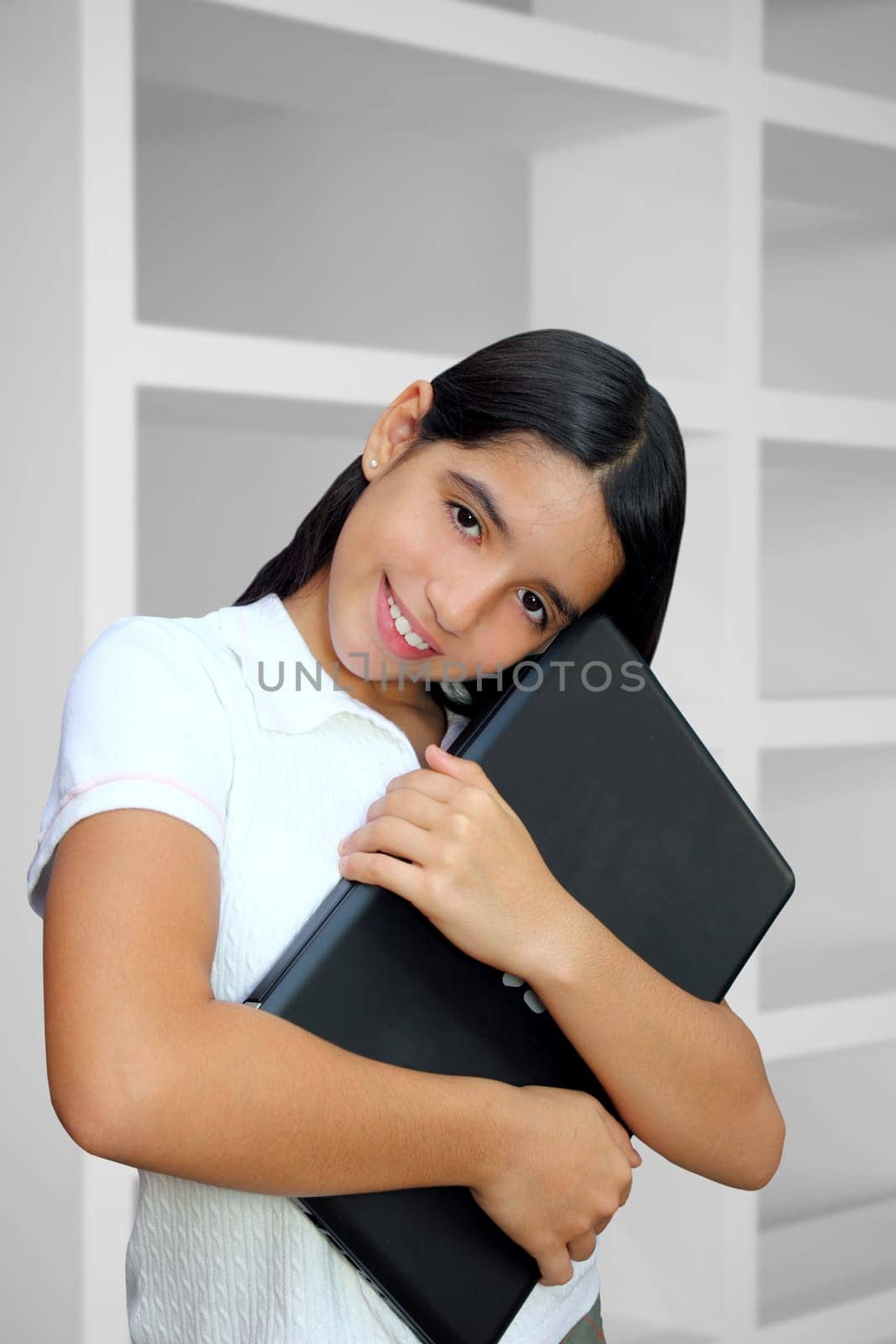 latin teenager brunette student hug laptop indoor white house
