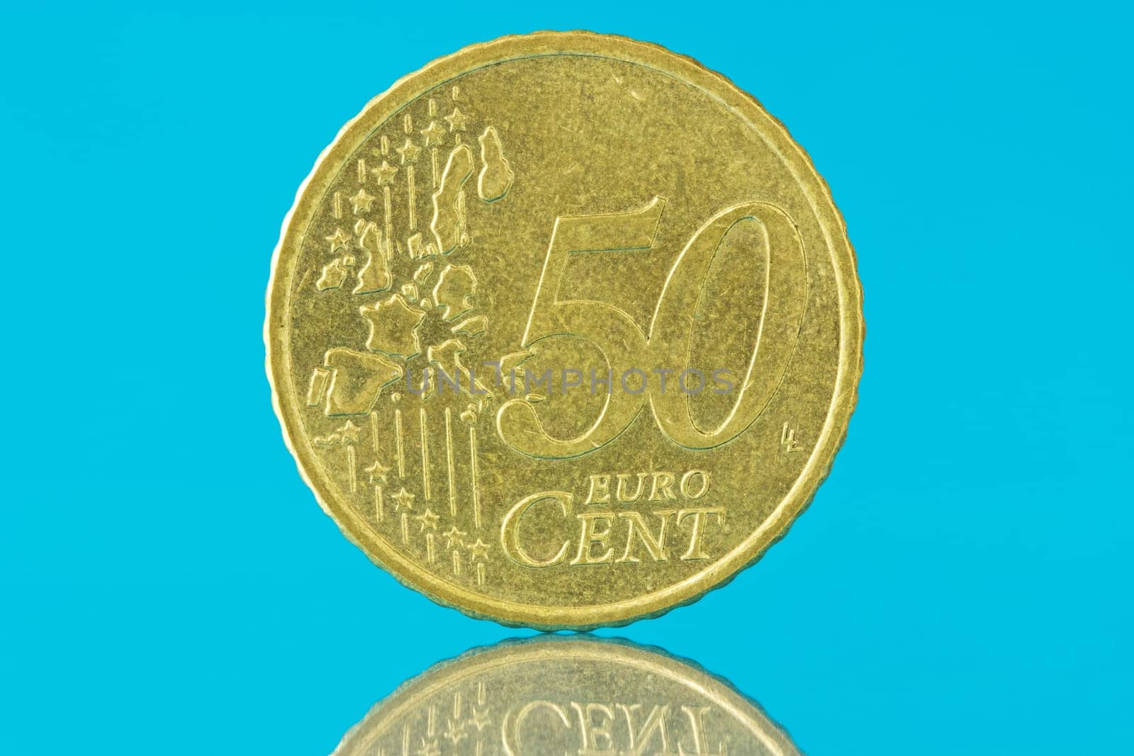 Fifty euro cent with reflection on blue background