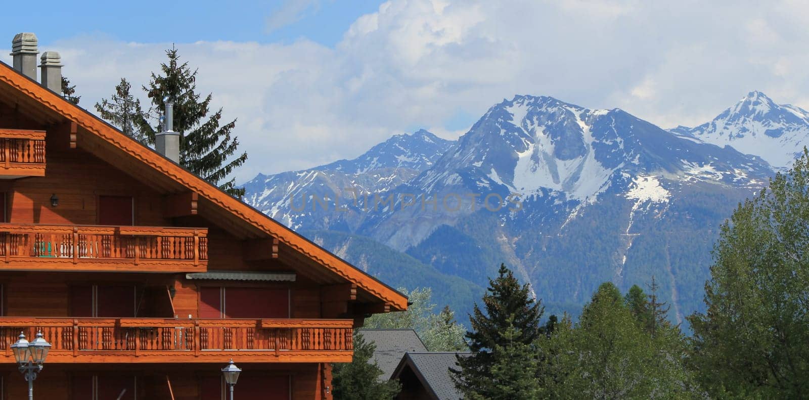 Swiss chalet and Alps mountains in summer, Crans Montana, Switzerland