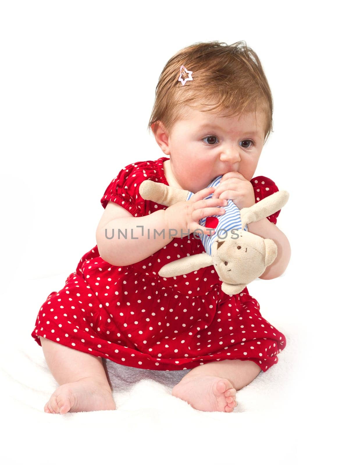 Happy baby sitting on white towel
