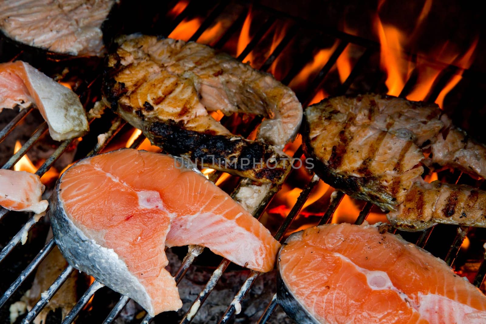 a fresh steak of salmon on grilled with flames