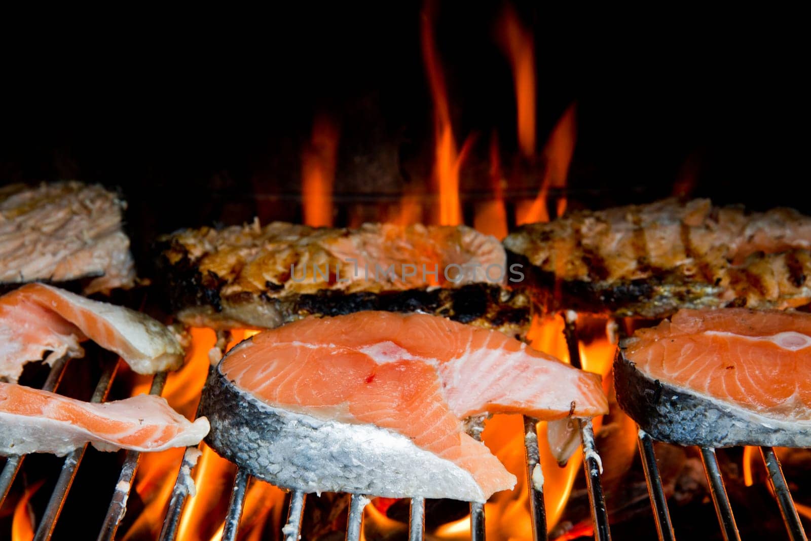 a fresh steak of salmon on grilled with flames