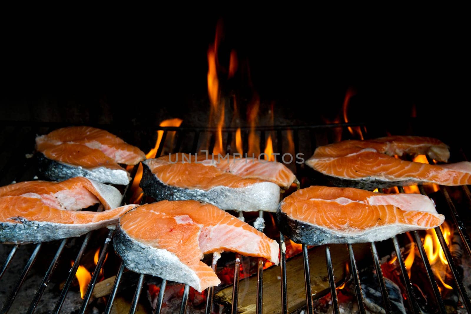 a fresh steak of salmon on grilled with flames