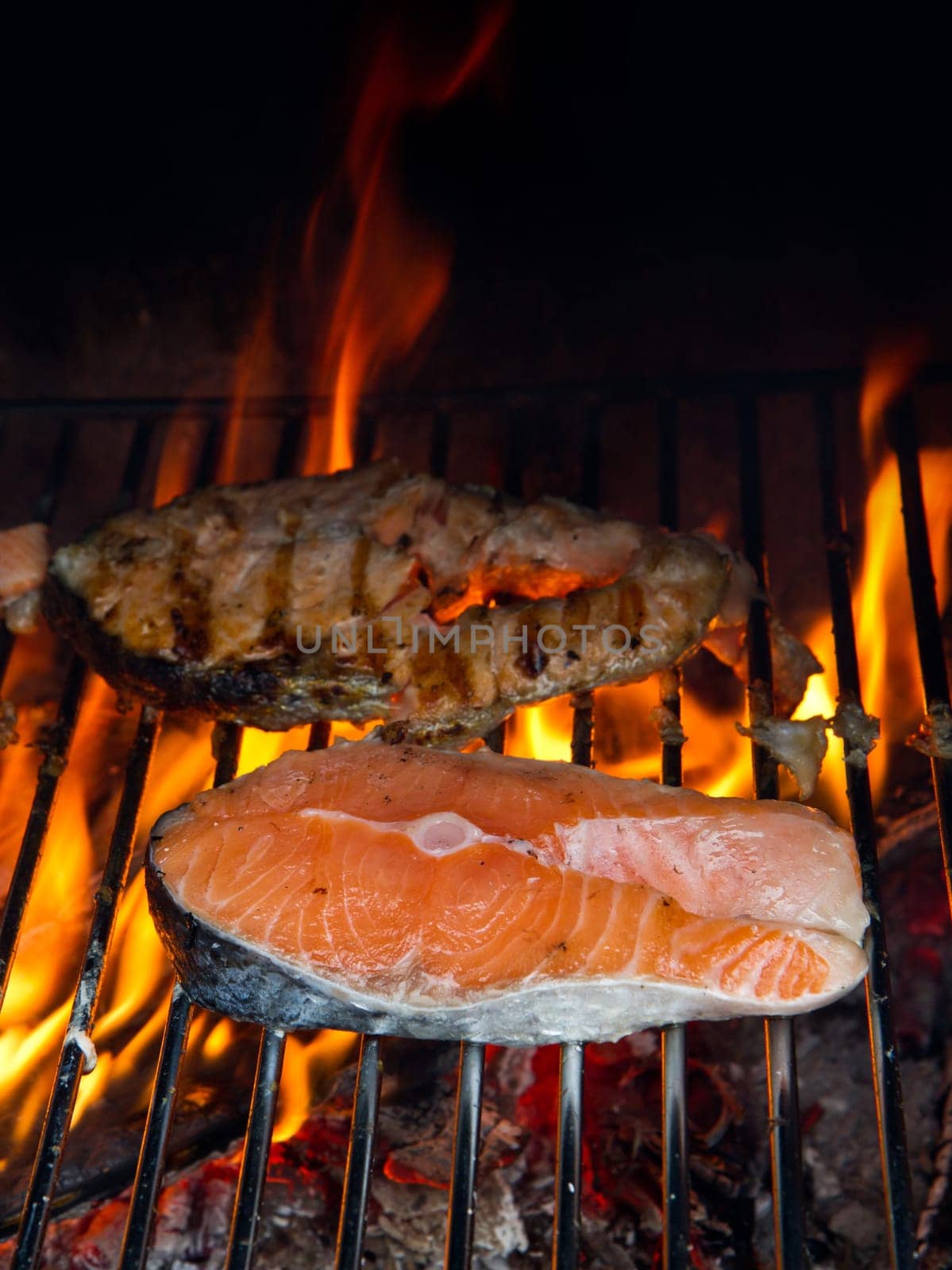 a fresh steak of salmon on grilled with flames
