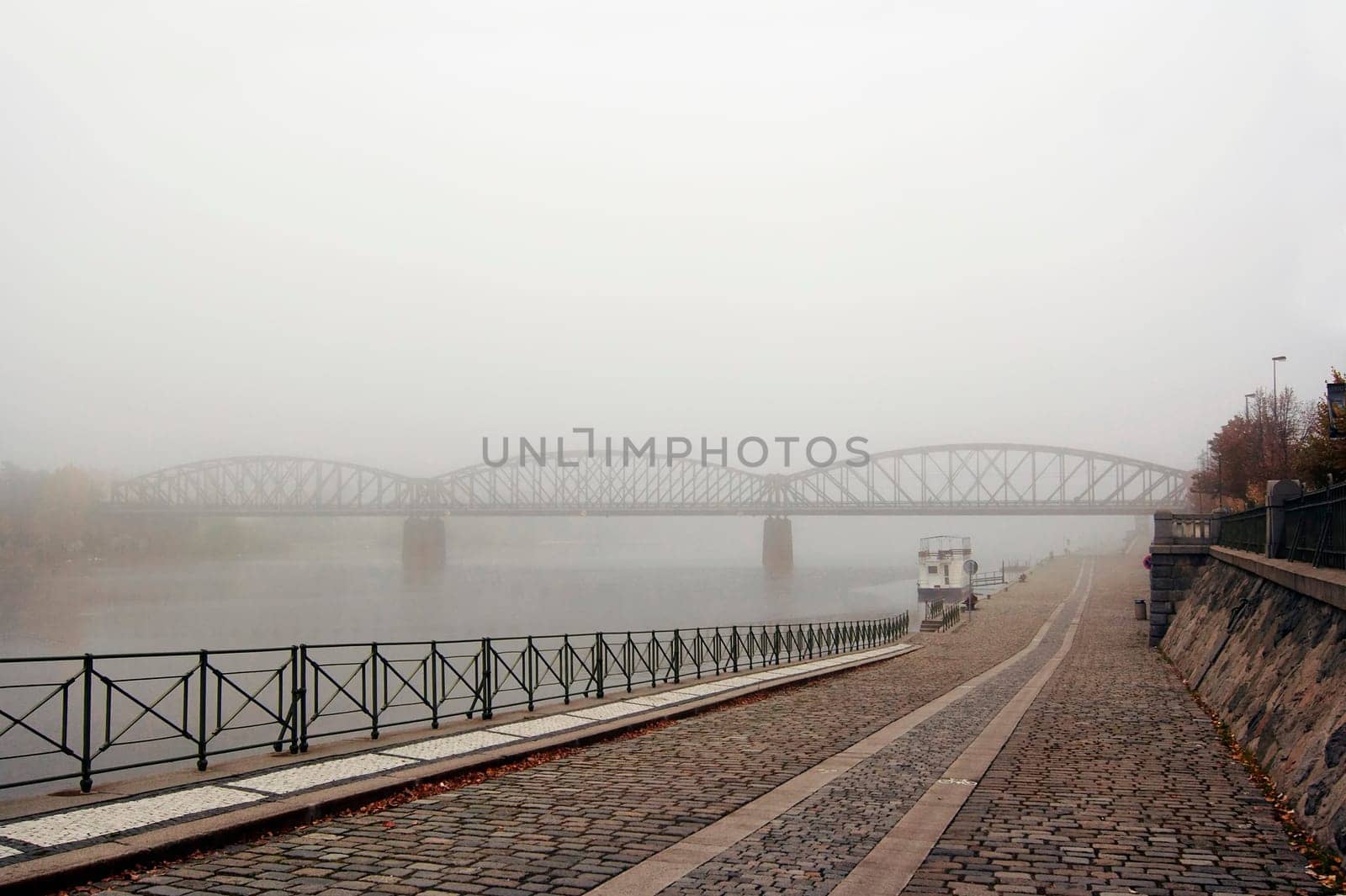 Prague railway bridge in early morning fog