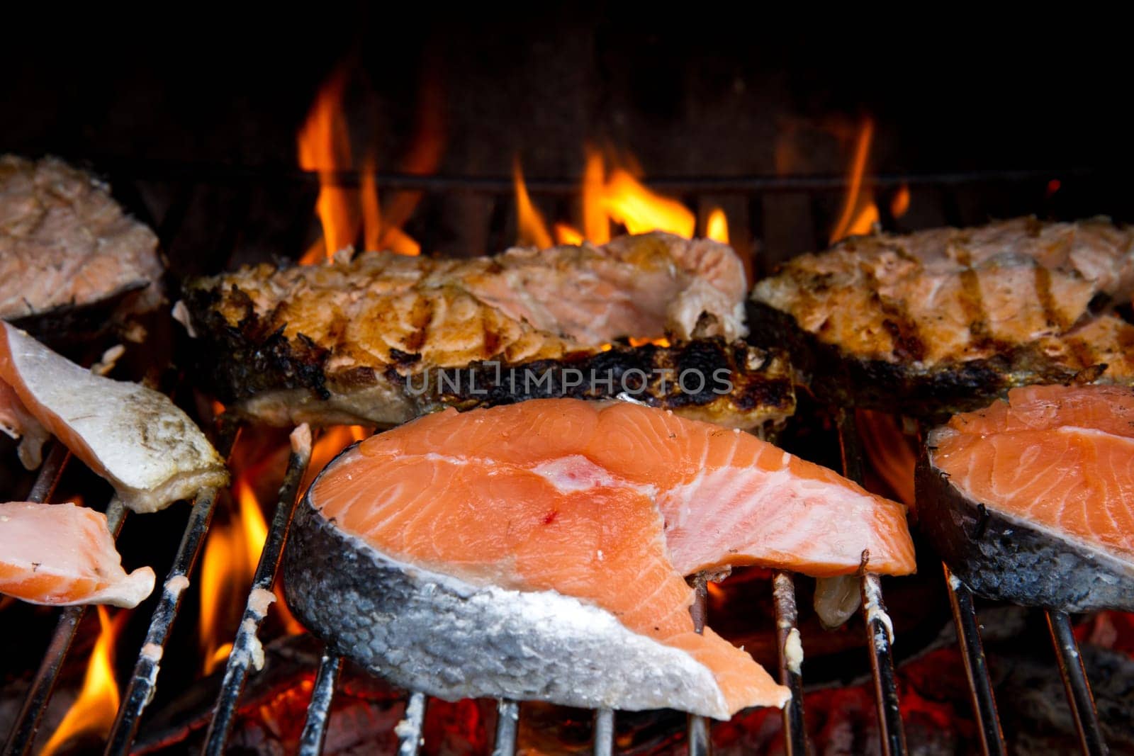 a fresh steak of salmon on grilled with flames