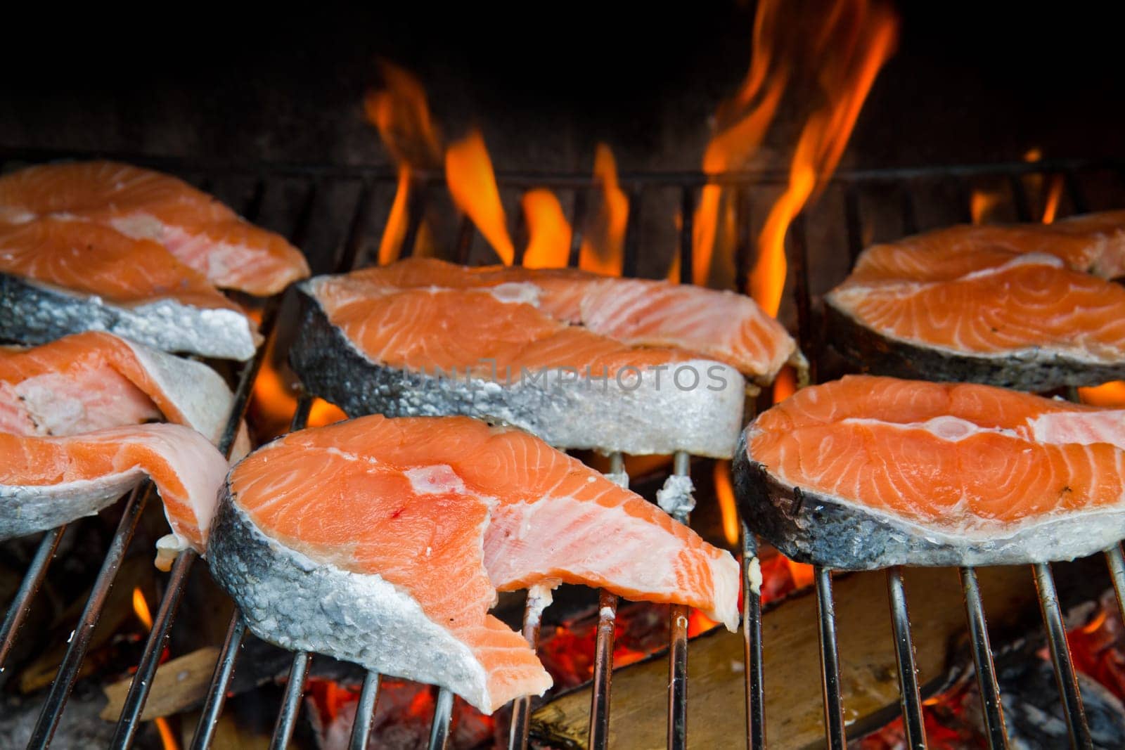 a fresh steak of salmon on grilled with flames