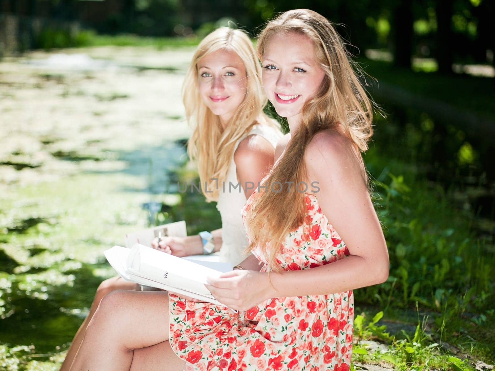 two gilrs are learning outside in the park