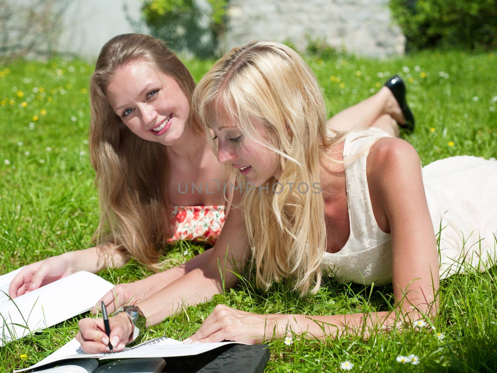 two gilrs are learning outside in the park