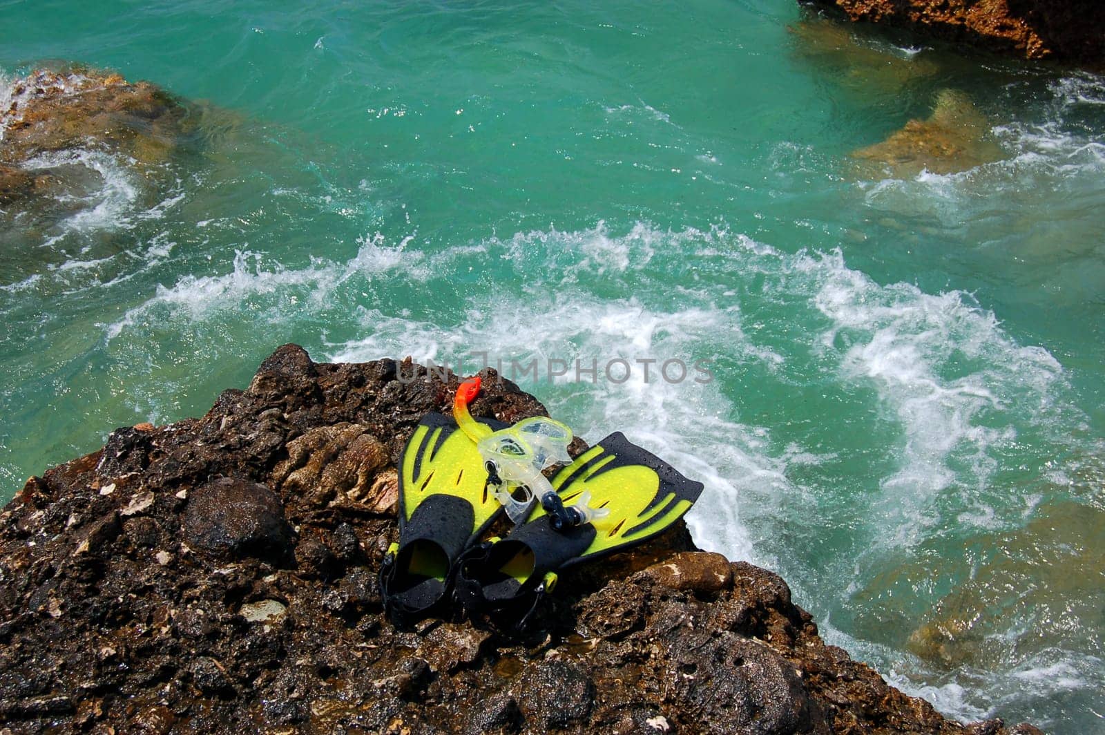 Snorkeling set on a rocky beach