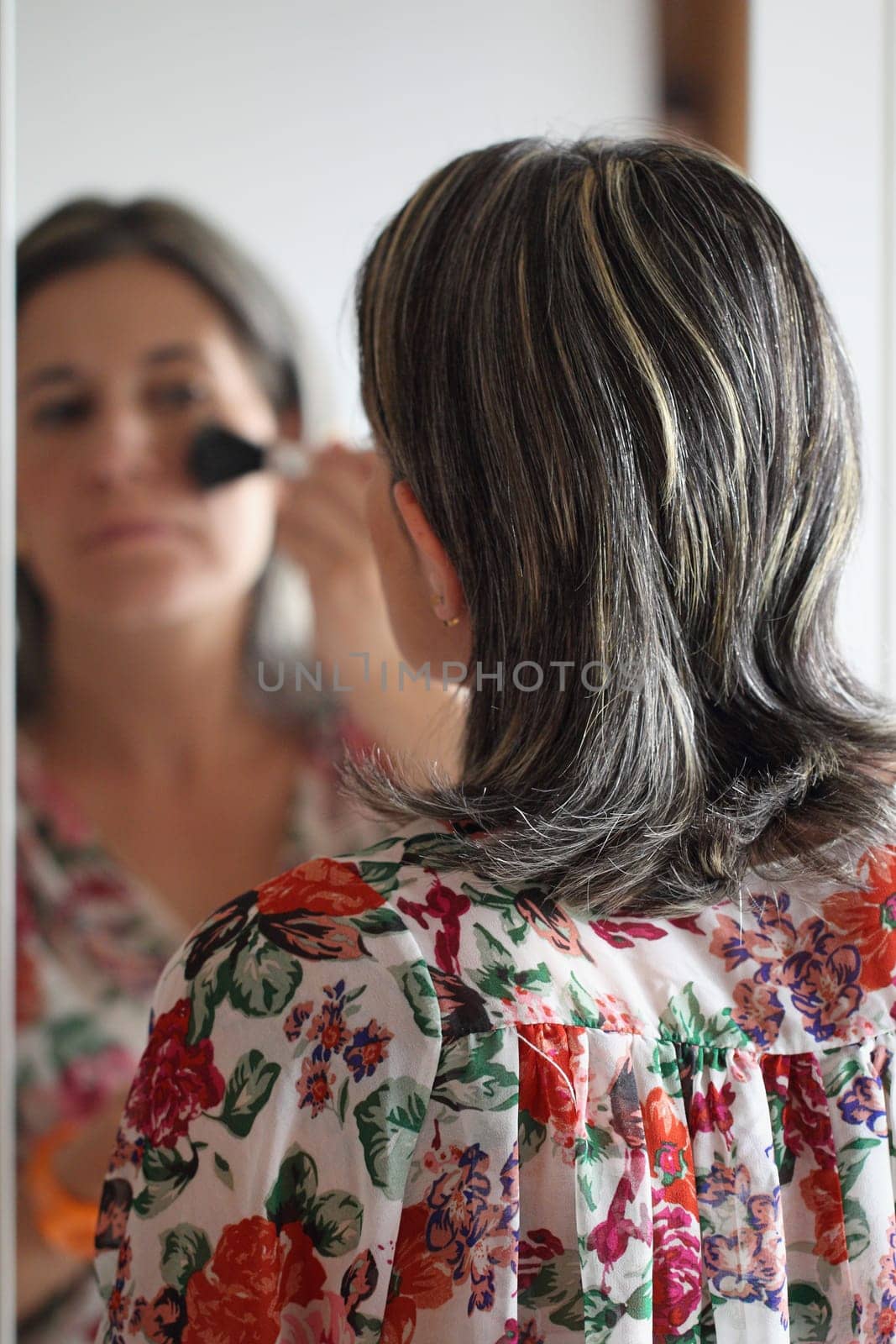 details of a woman applying make-up