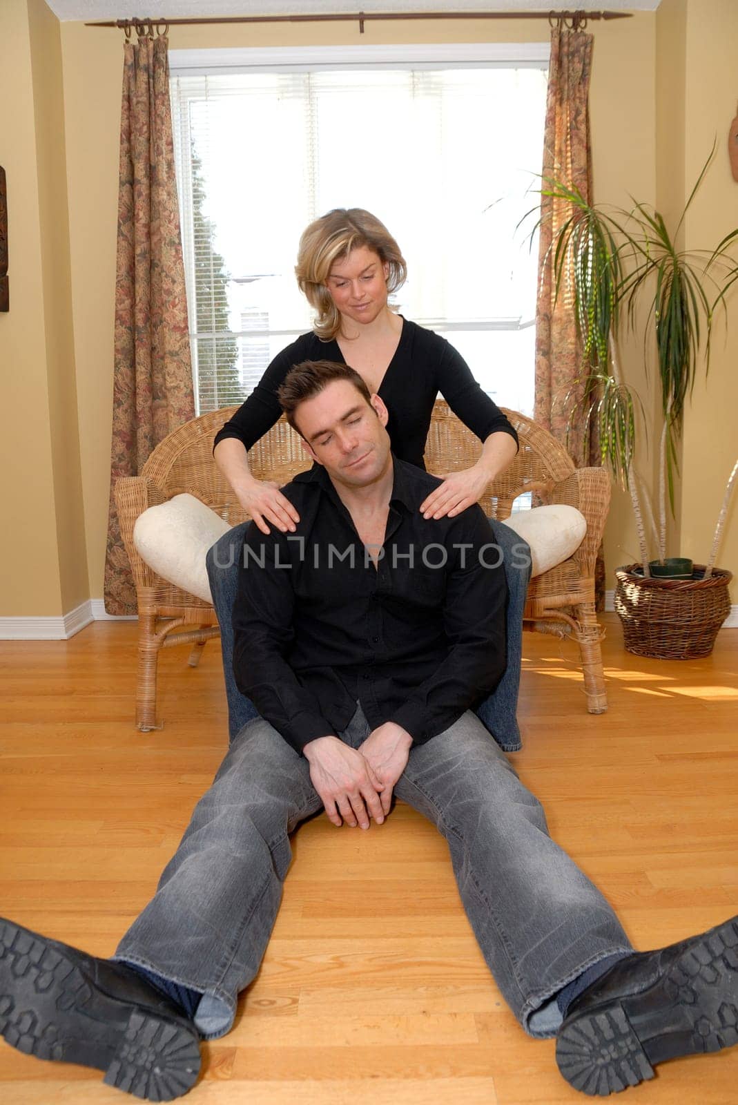 couple in the living room with woman giving a massage