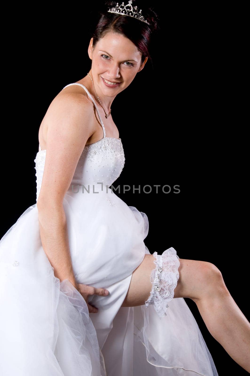 White Bride at her wedding posing with veil