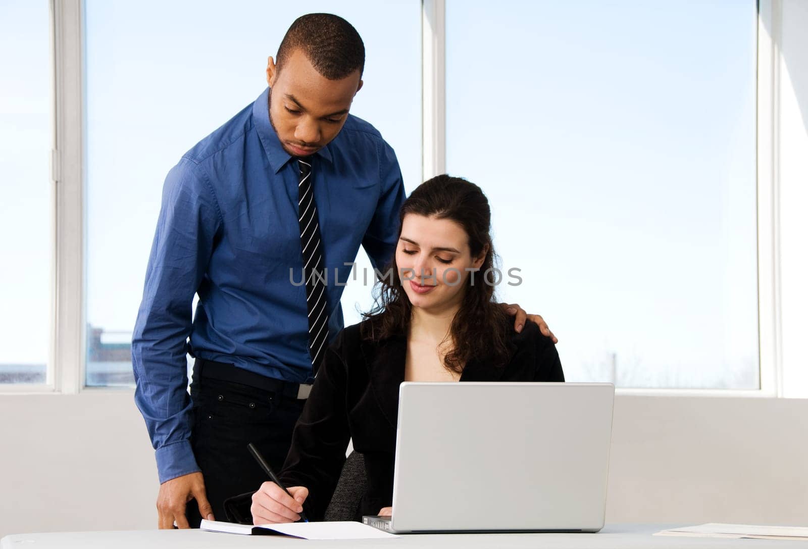 male and female business partners in a window office