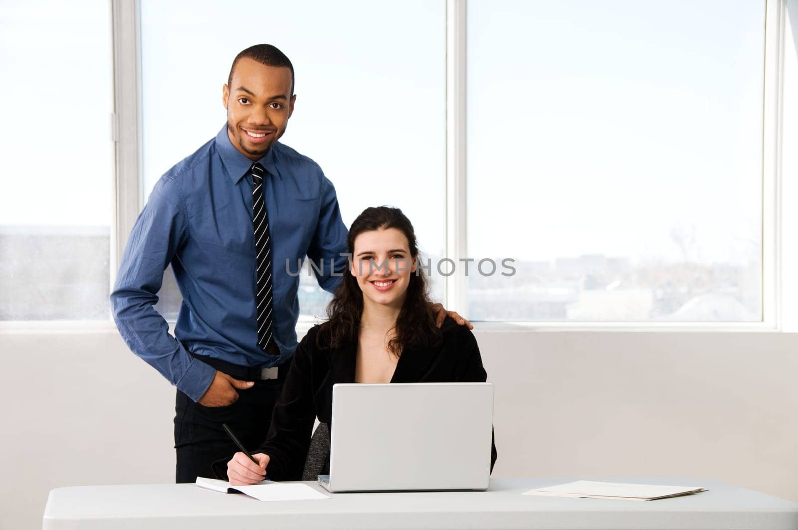 male and female business partners in a window office