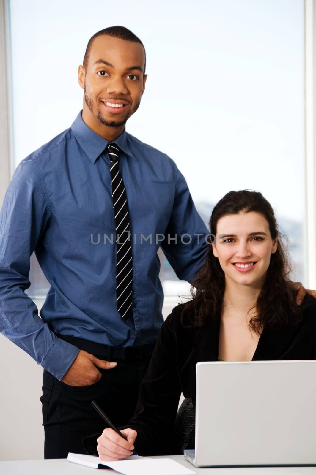 male and female business partners in a window office