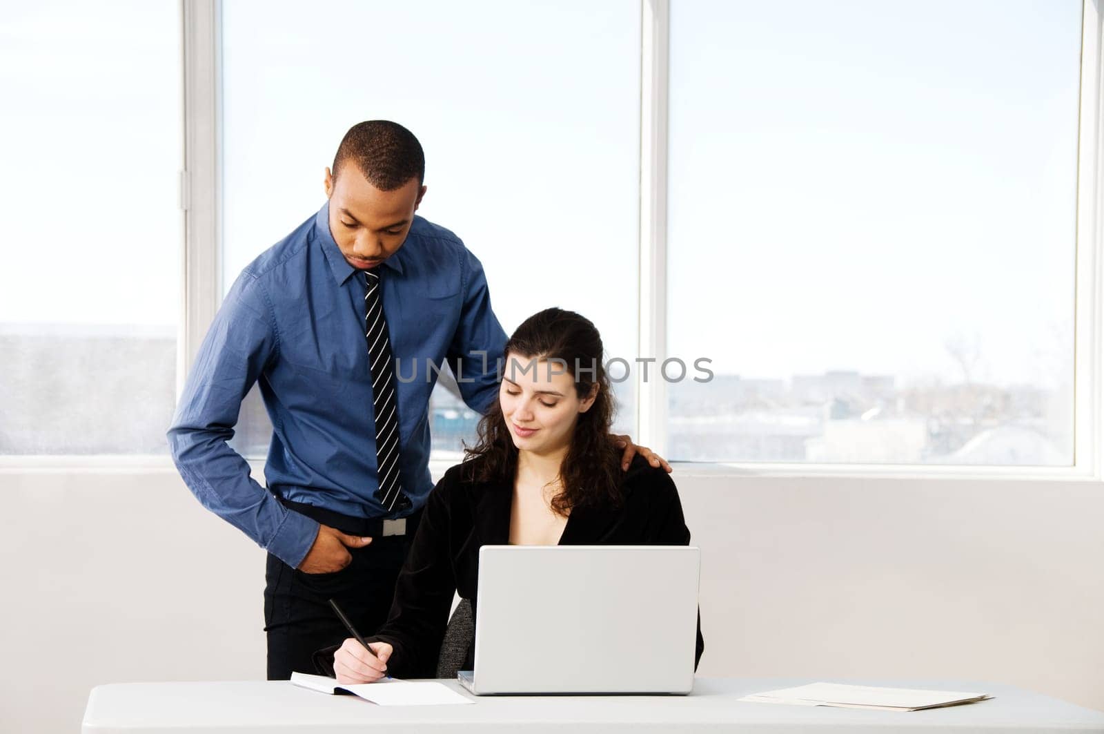 male and female business partners in a window office