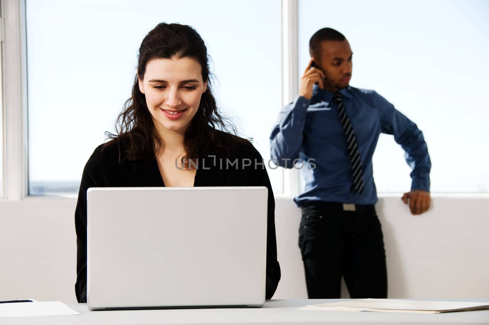 male and female business partners in a window office