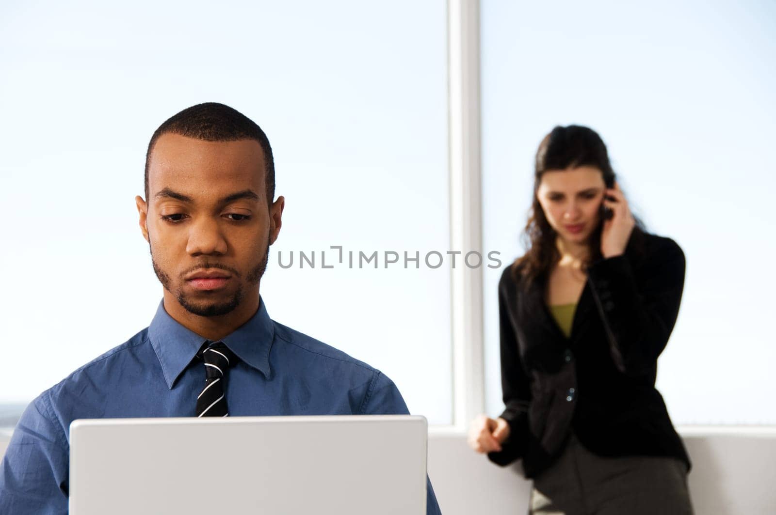 male and female business partners in a window office