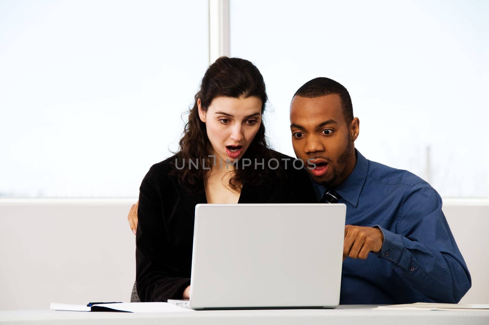 male and female business partners in a window office