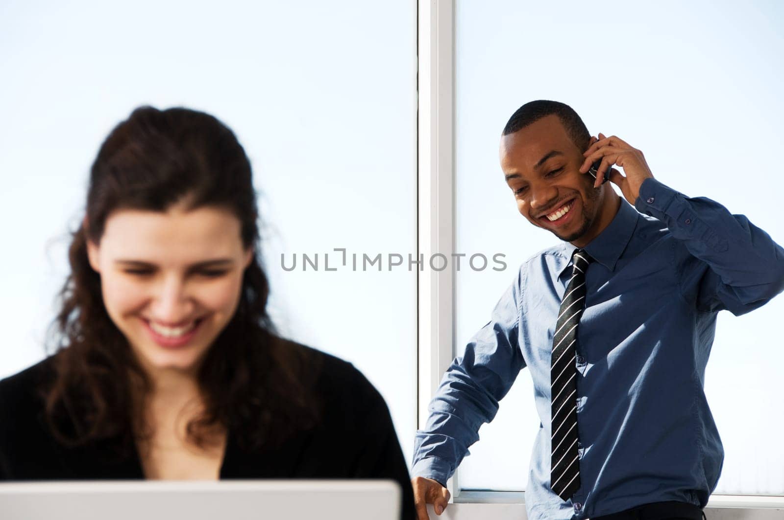 male and female business partners in a window office