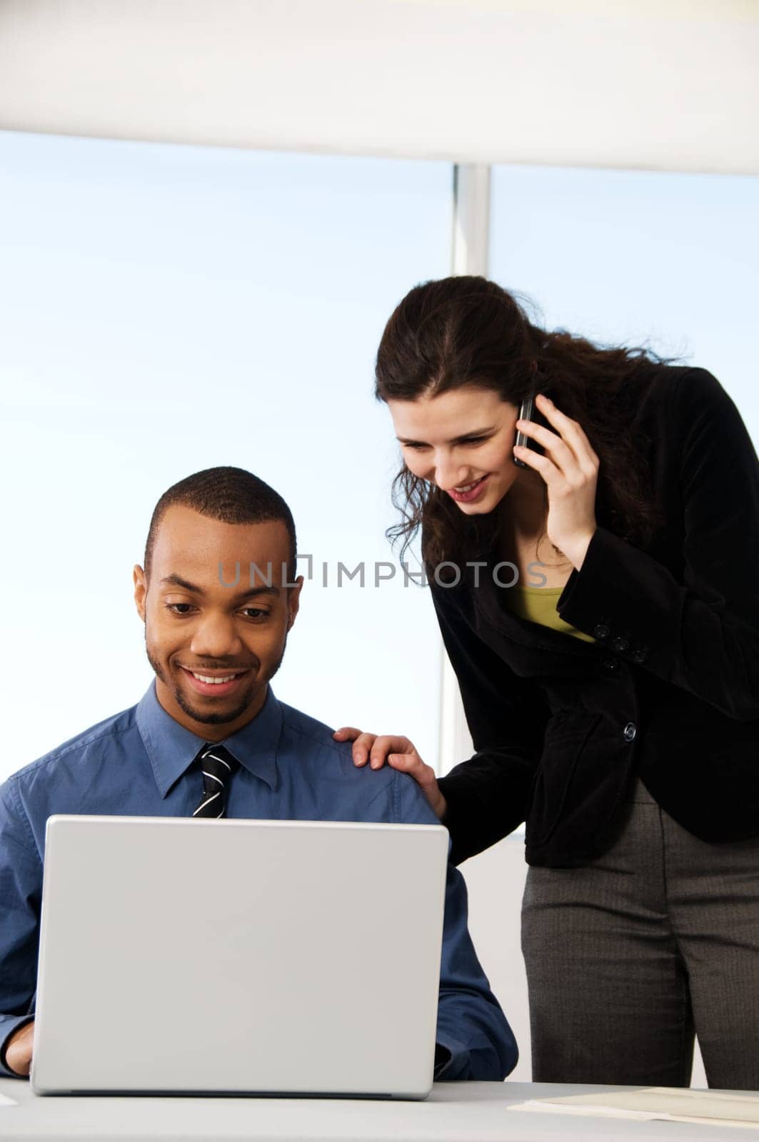 male and female business partners in a window office