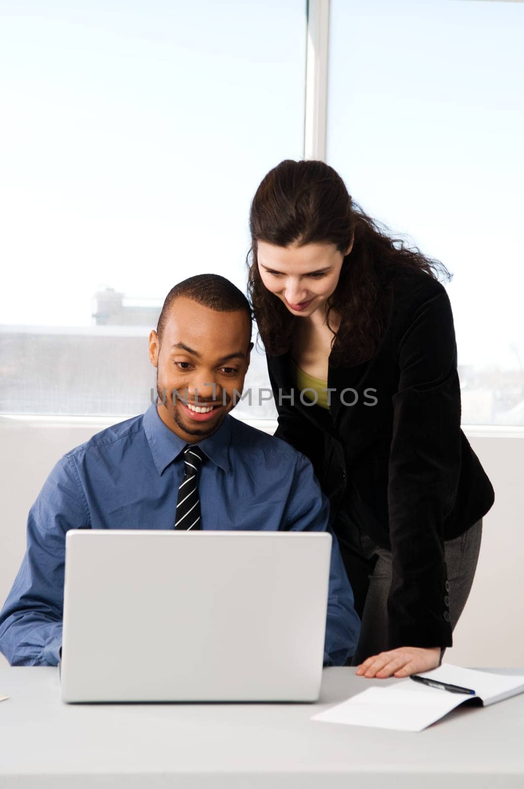 male and female business partners in a window office