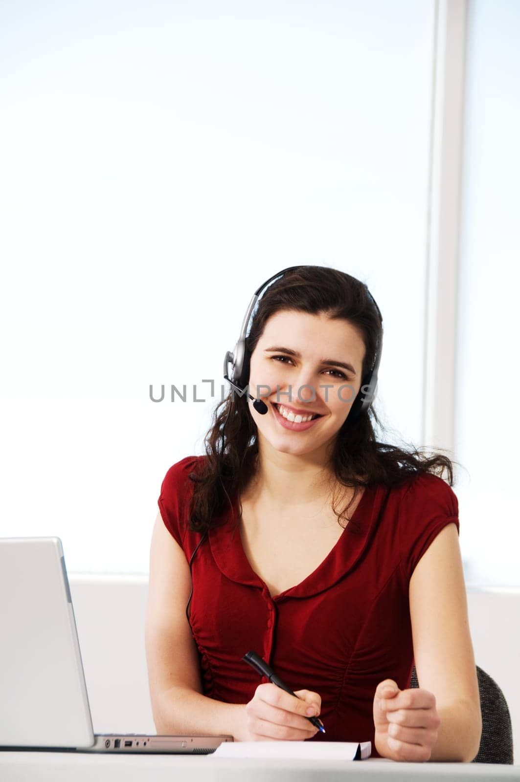 cute woman worker in an office with a headset